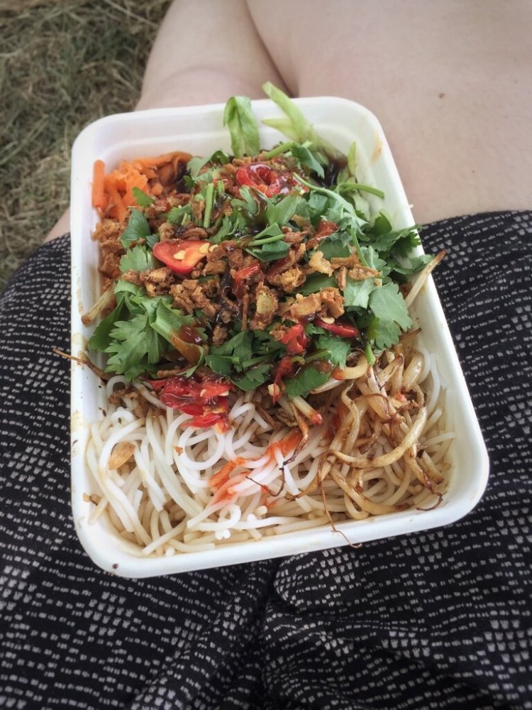 Closeup of a Thai noodle dish in a to-go container.