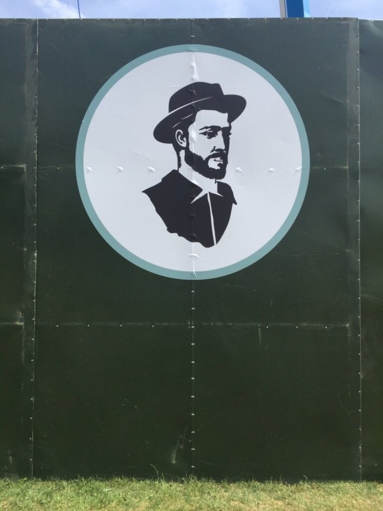A painted silhouette of a bearded man with a hat on a wall.